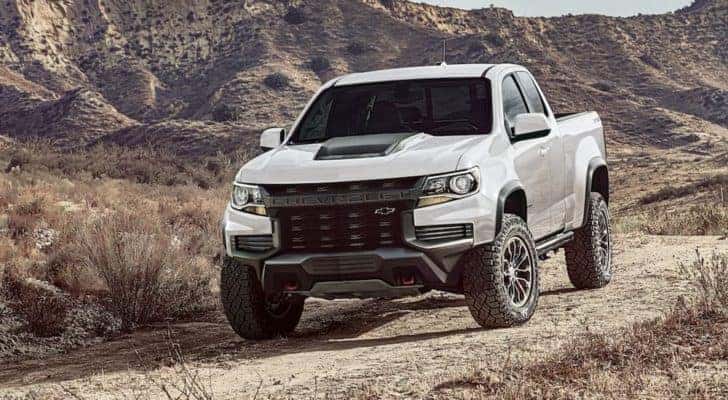 A white 2022 Chevy Colorado is shown from the front parked in the desert after leaving a NY Chevy Colorado dealer.
