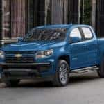 A blue 2022 Chevy Colorado is shown from the side parked on a city street after leaving a NY Chevy Colorado dealer.