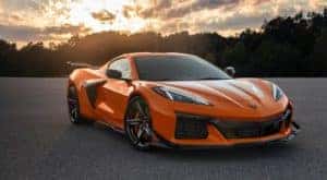 An orange 2023 Chevy Corvette Z06 is shown on a sunny day after visiting a NY Corvette dealership.