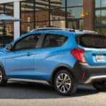 A blue 2018 Chevy Spark is shown from the rear at an angle.