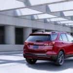 A red 2022 Chevy Equinox RS is shown from behind on a covered highway.