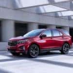 A red 2022 Chevy Equinox RS is shown from the side after leaving a NY Chevy Equinox dealer.
