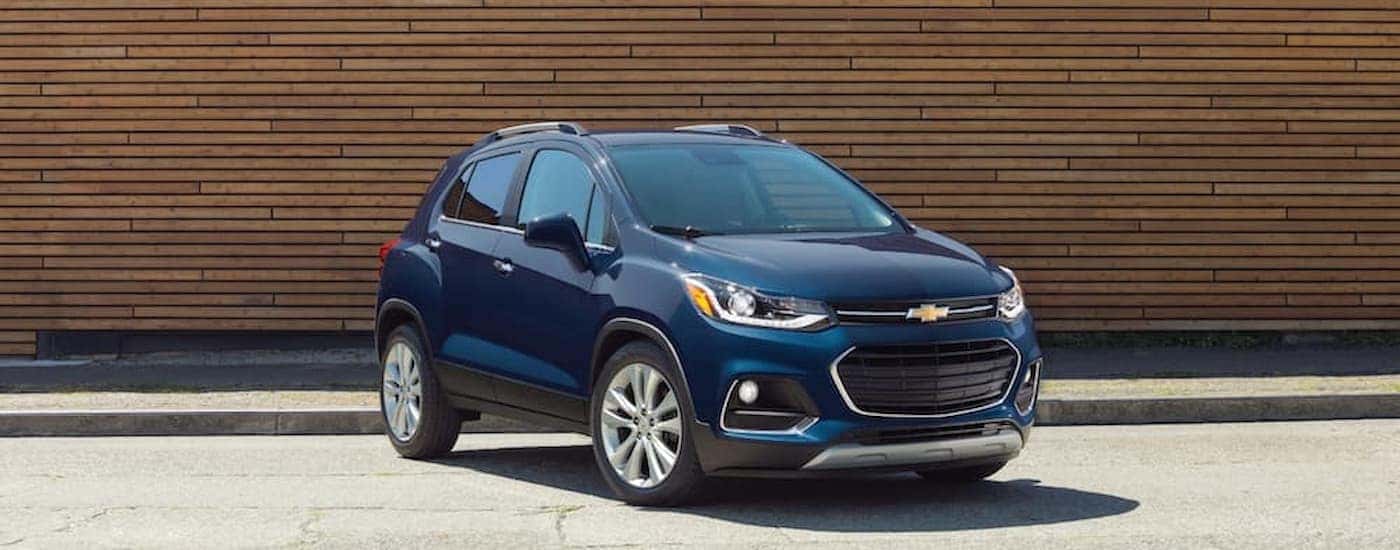 A blue 2018 Chevy Trax is shown parked in front near an Albany Chevrolet dealership.