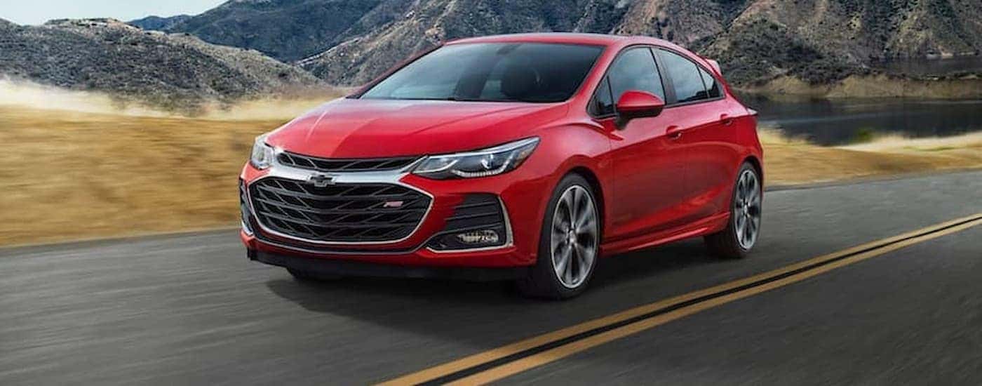 A red 2019 Chevy Cruze RS is shown leaving an Albany, NY, Chevy dealer.