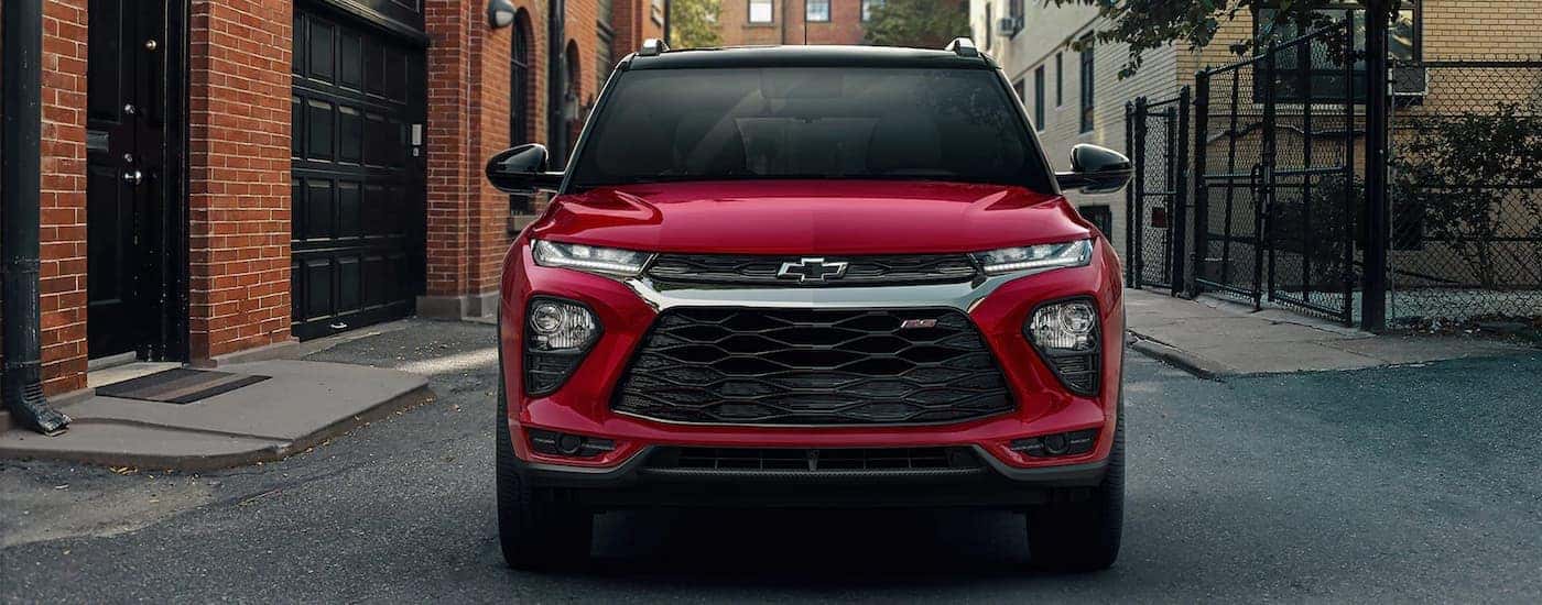A red 2022 Chevy Trailblazer is shown from the front driving on a city street.