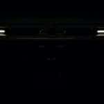 A 2023 Chevy Silverado 1500 ZR2 Bison is shown from the front parked in the dark with headlights on.