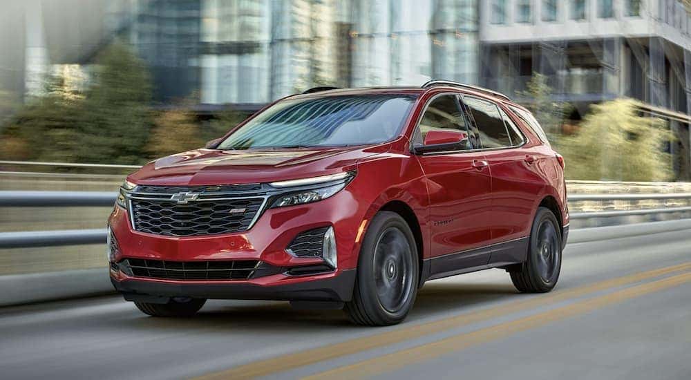 A red 2022 Chevy Equinox RS is shown from the front driving on a highway.