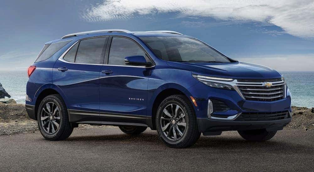 A blue 2022 Chevy Equinox is shown from the side parked in front of an ocean after leaving a Chevy Equinox dealer near you.