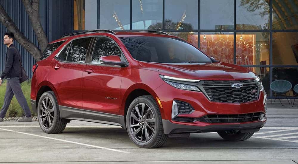 A red 2022 Chevy Equinox is shown parked at a Troy Equinox dealer.