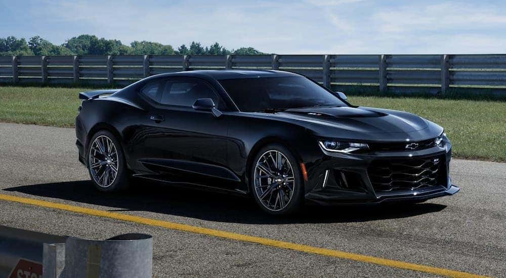A black 2020 Chevy Camaro is shown on a track.
