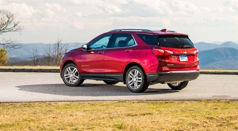 A popular used Chevy near you, a red 2020 Chevy Equinox, is shown from the rear.