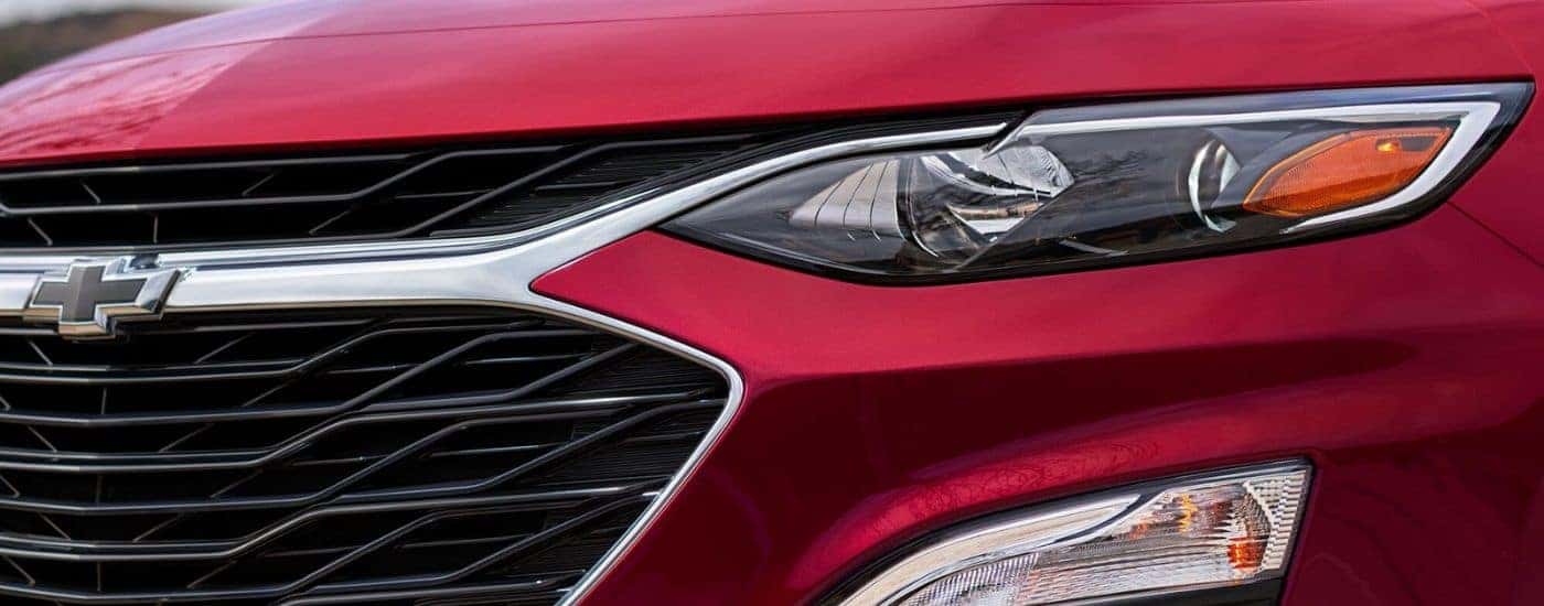 Headlight and grille on a red 2023 Chevy Malibu