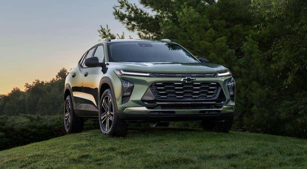A green 2024 Chevy Trax Activ is shown parked on a hill.