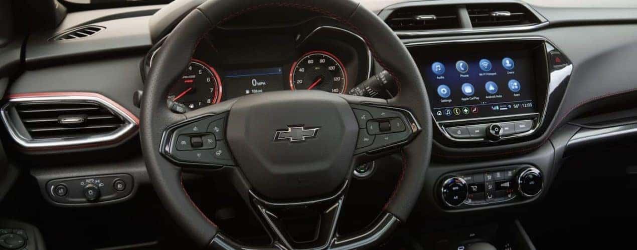 The black interior 2023 Chevy Trailblazer shows the steering wheel and infotainment screen.