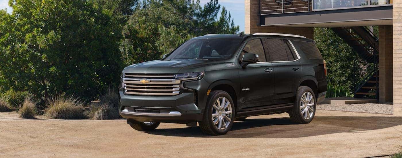 A green 2022 Chevy Tahoe is shown from the front after leaving a Chevy SUV dealer.