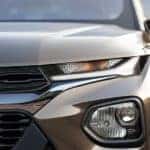 A close up of the headlight of a brown 2022 Chevy Trailblazer for sale is shown.