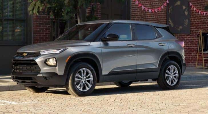 A grey 2023 Chevy Trailblazer is shown from the side parked on a side of a city street.
