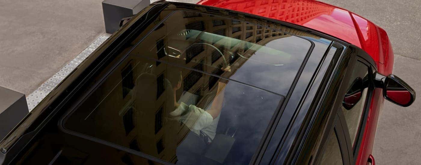 The sunroof of a red 2023 Chevy Trailblazer for sale is shown from a high angle. 