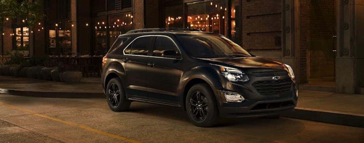 A black 2017 Chevy Equinox is shown from the side at night.