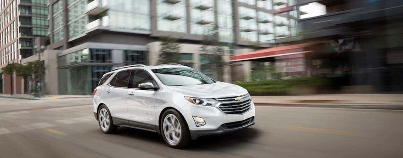 A white 2018 Chevy Equinox is shown from the front at an angle after leaving a dealer that had a used Equinox in Saratoga NY.