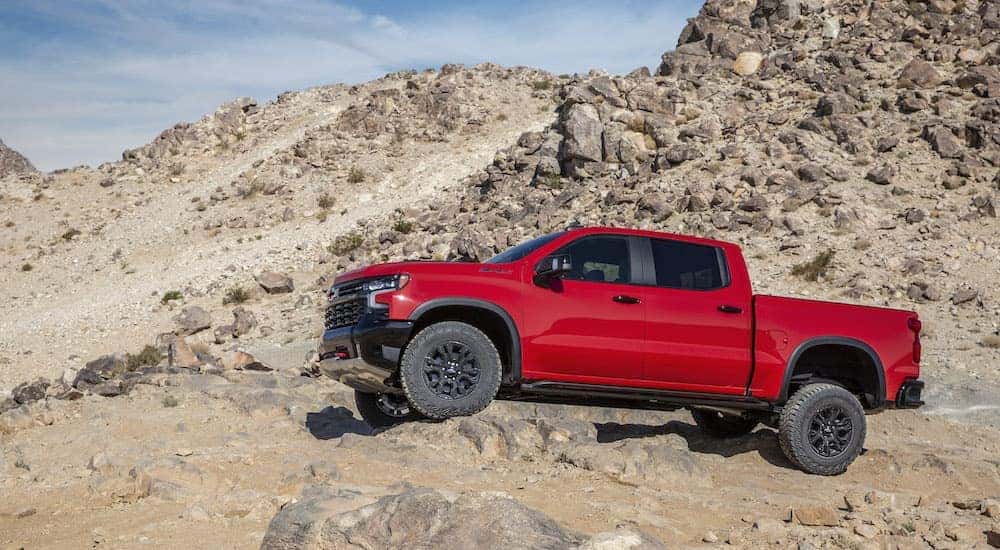 A red 2022 Chevy Silverado 1500 ZR2 is shown from the side after leaving a  Chevy truck dealer.