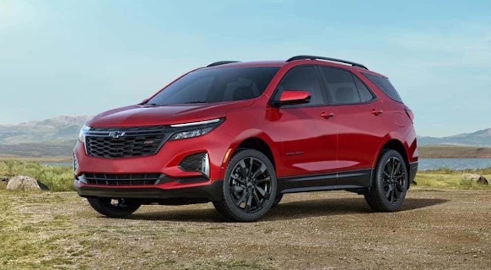 A red 2022 Chevy Equinox RS is shown from the side after leaving a dealer that has a used Equinox Saratoga NY.