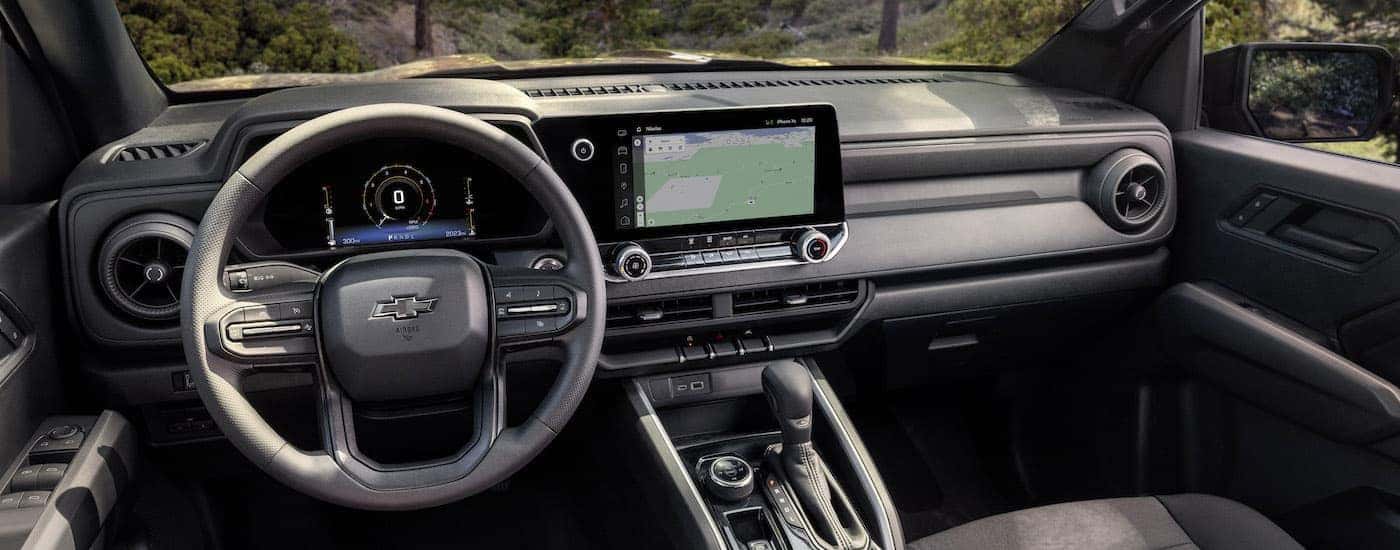 The black interior of a 2023 Chevy Colorado Trail Boss is shown from the drivers seat.