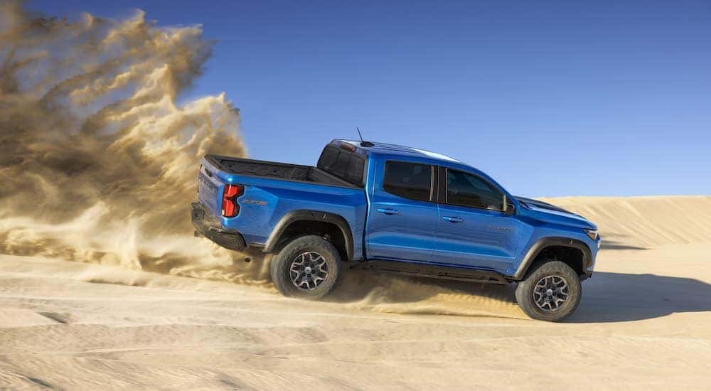 Blue 2023 Chevy Colorado ZR2 in Saratoga NY kicking up sand