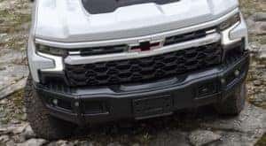 A close up of the front of a white 2023 Chevy Silverado ZR2 Bison is shown after leaving a Chevy truck dealer.