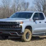 A grey 2023 Chevy Silverado Trail Boss is shown from the front at an angle after leaving a NY Chevy Silverado dealer.