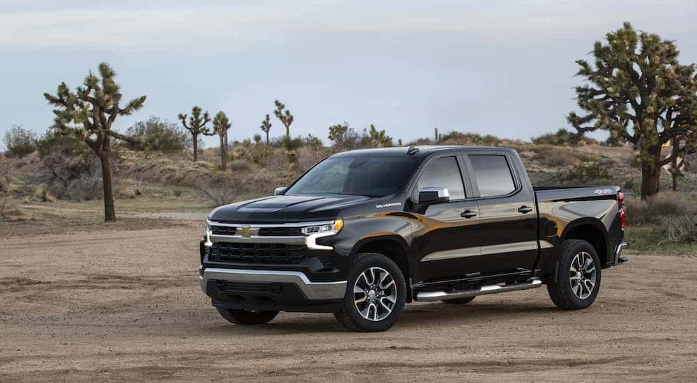 A black 2023 Chevy Silverado 1500 LT is shown from the front at an angle.