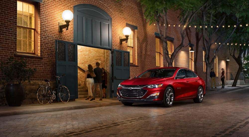 A red 2019 Chevy Malibu is shown from the front at an angle after leaving a Saratoga, NY Chevy Malibu dealer.