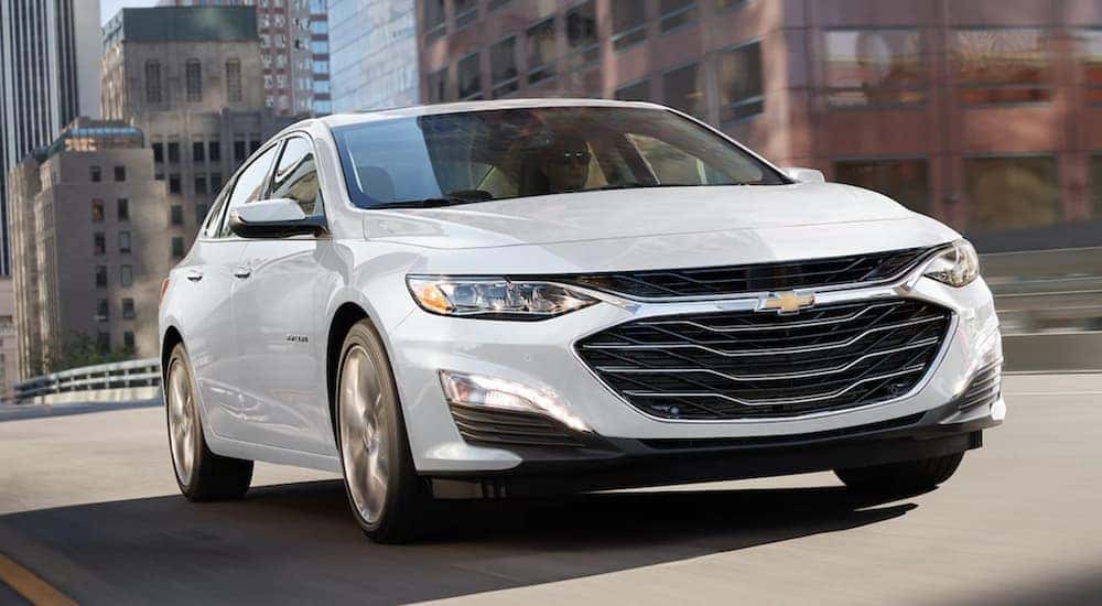 A white 2021 Chevy Malibu is shown from the front at an angle.