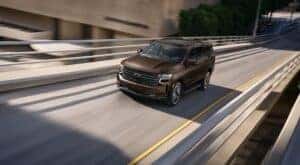 A brown 2022 Chevy Tahoe is shown from the front at an angle after leaving a Saratoga, NY Certified Pre-owned Chevy SUV dealer.