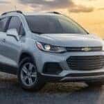 A silver 2021 Chevy Trax is shown parked on the sand after visiting Saratoga, NY Certified Pre-Owned Chevy SUV dealer.