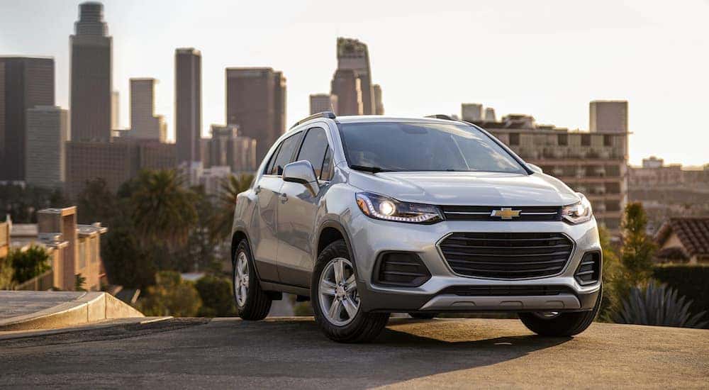A silver 2021 Chevy Trax is shown from the front at an angle after leaving a dealer that has used cars for sale.