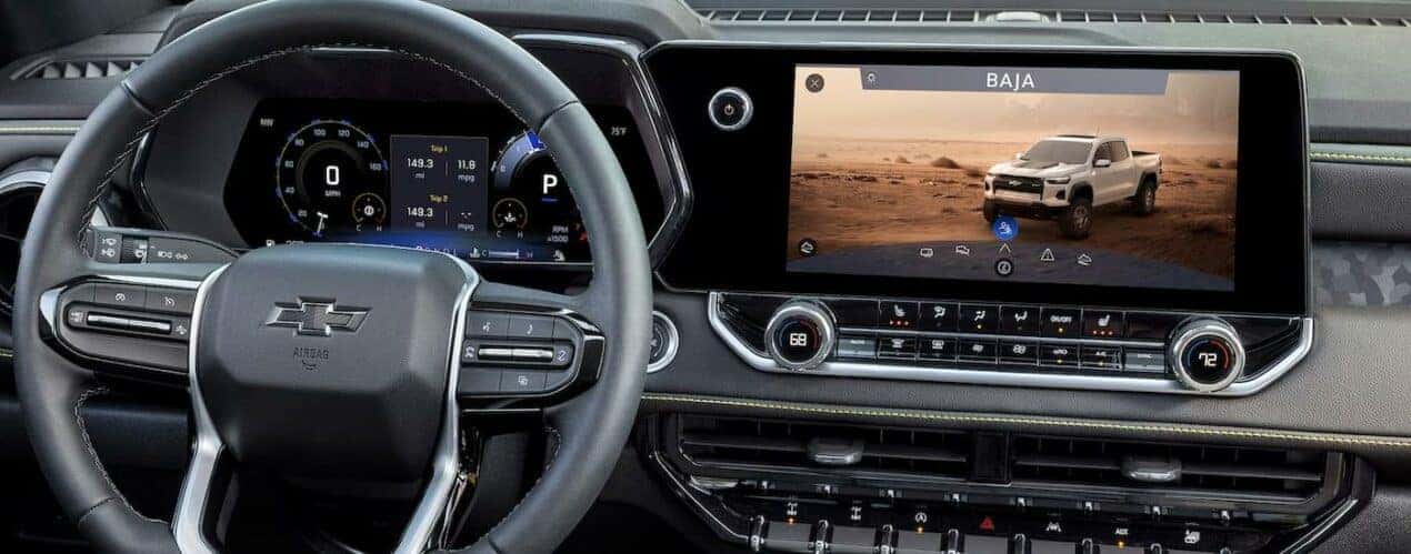 The steering wheel and infotainment screen of a 2023 Chevy Colorado is shown.