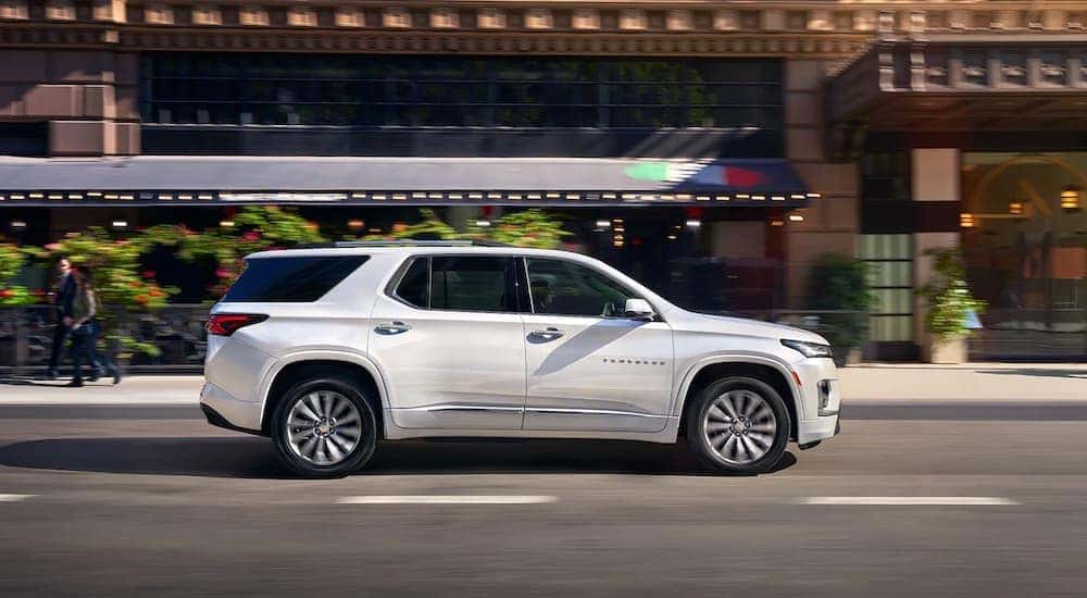 A white 2023 Chevy Traverse is shown from the side after leaving a Chevy dealer near Troy.