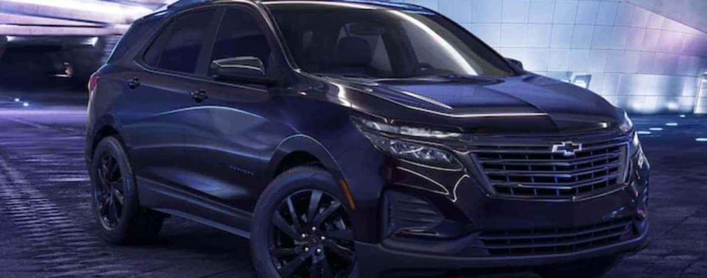 A black 2023 Chevy Equinox Midnight Edittion is shown parked in a garage.