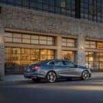 A grey 2021 Chevy Malibu is shown from the rear at an angle.