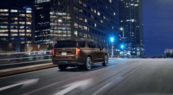 A brown 2022 Chevy Suburban RST is shown from the rear at an angle.
