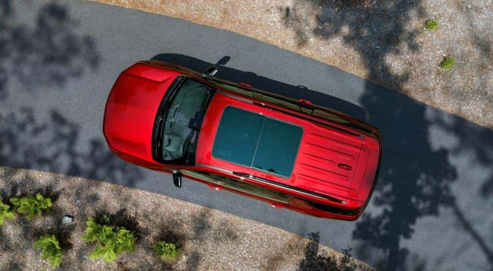 A red 2024 Chevy Traverse RS is shown from a high angle.
