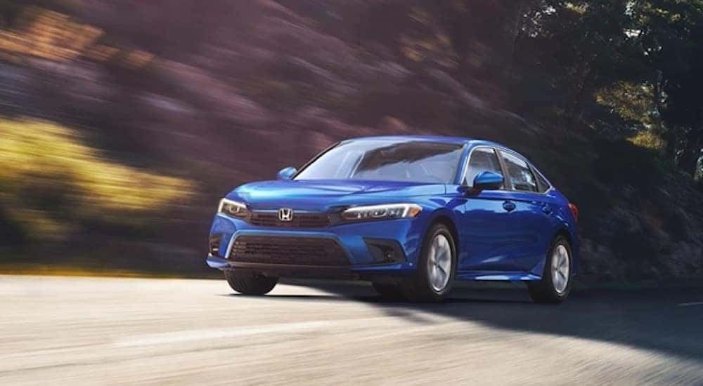 A blue 2022 Honda Civic is shown from the front at an angle.