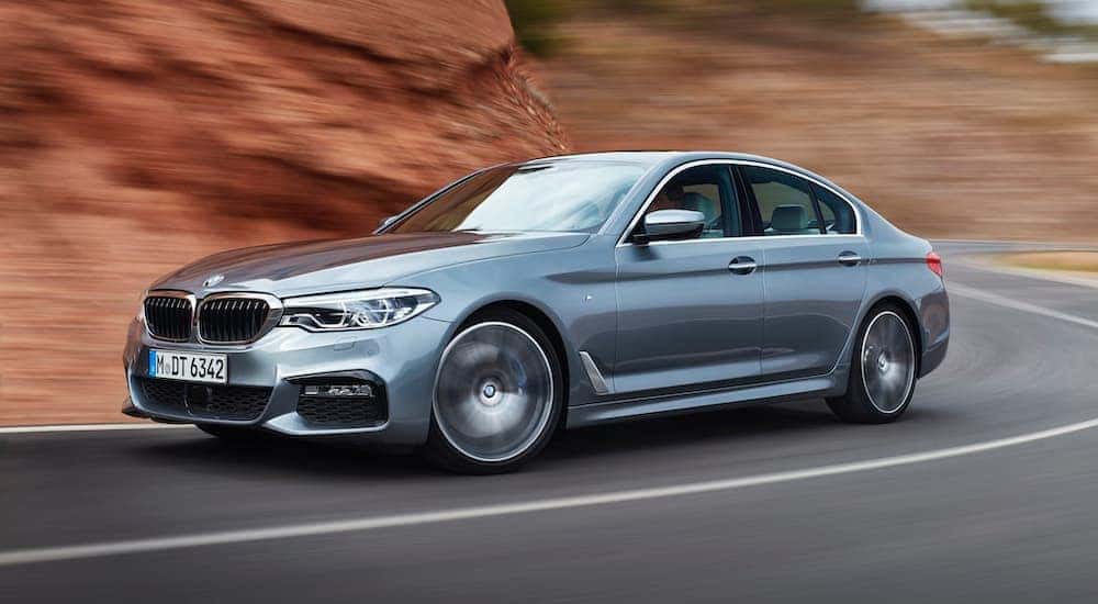 A grey 2017 BMW 5 series is shown from the side.