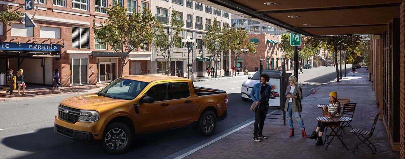 A yellow 2023 Ford Maverick is shown from the front at an angle.