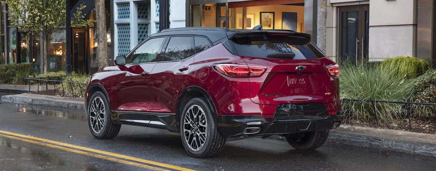 A red 2023 Chevy Blazer RS is shown from the rear at an angle after leaving a dealer that has used SUVs for sale.