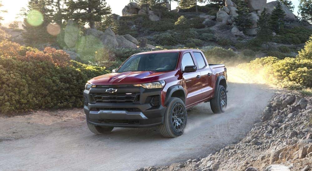 A red 2023 Chevy Colorado Z71 is shown driving off-road.