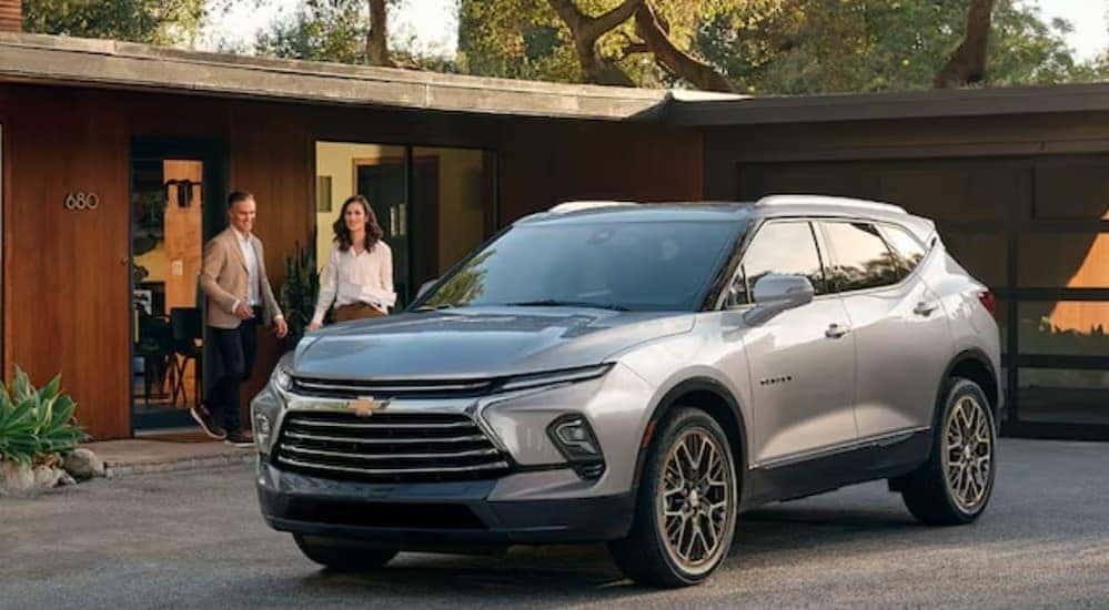 A silver 2024 Chevy Blazer is shown parked near as house.