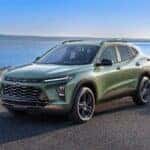 A green 2024 Chevy Trax Activ is shown from the front at an angle after leaving a Chevy dealer near Cohoes.