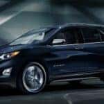 One of many popular Used SUVs for sale in Albany, a blue 2020 Chevy Equinox, is shown driving in a tunnel.